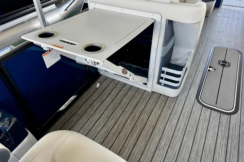 Slide: The Image of Interior of 2026 Harris Grand Mariner 250 SLDH with fold-out table and cup holders. - 14