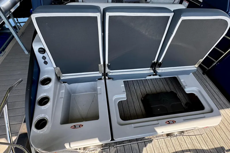 Slide: The Image of 2026 Harris Grand Mariner 250 SLDH boat seating with storage compartments and cup holders. - 16