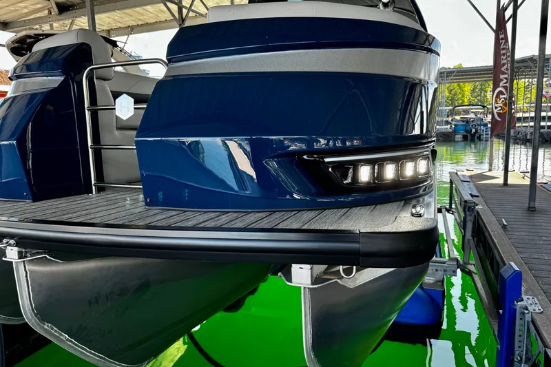 Slide: The Image of 2026 Harris Grand Mariner 250 SLDH pontoon boat docked, featuring sleek design and LED lights. - 23