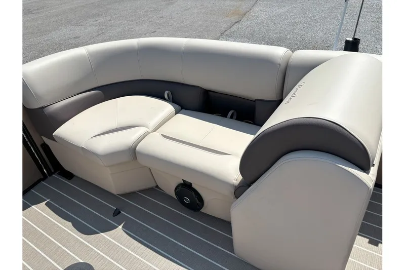 Slide: The Image of The image shows a luxurious seating area on a pontoon boat with cream-colored upholstery. - 19