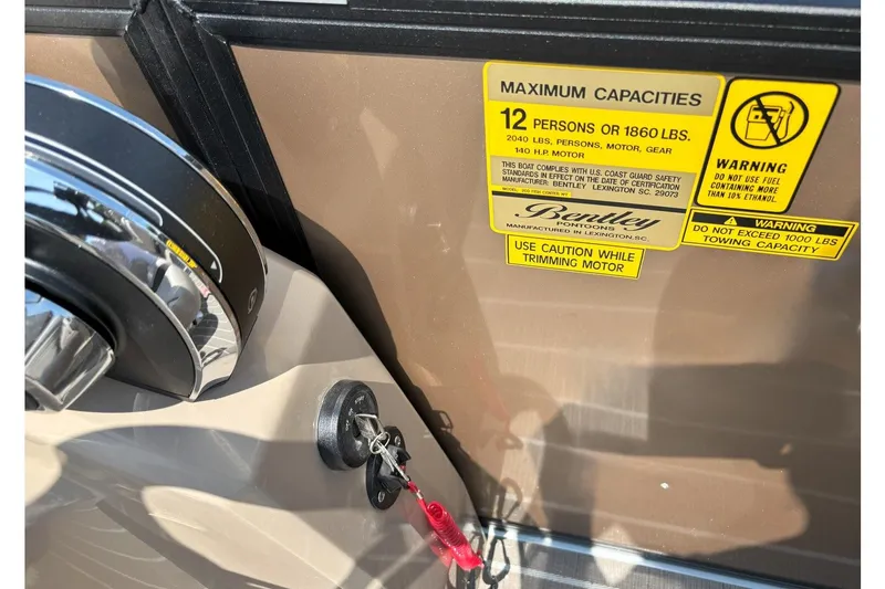 Slide: The Image of Close-up of a boat key and warning labels on a Bentley Pontoons FISH 200 CW. - 7