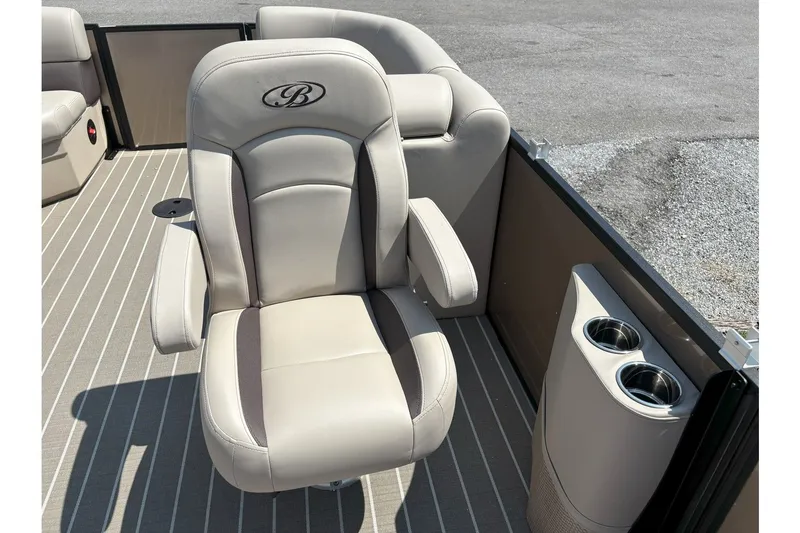 Slide: The Image of A luxurious captain's chair on a Bentley pontoon boat with cup holders beside it. - 9