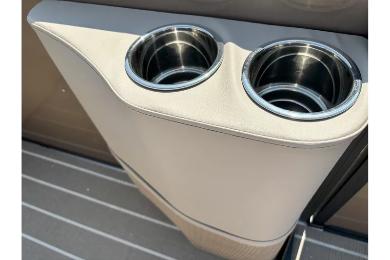 Slide: The Image of Two stainless steel cup holders in a beige armrest on a boat. - 10