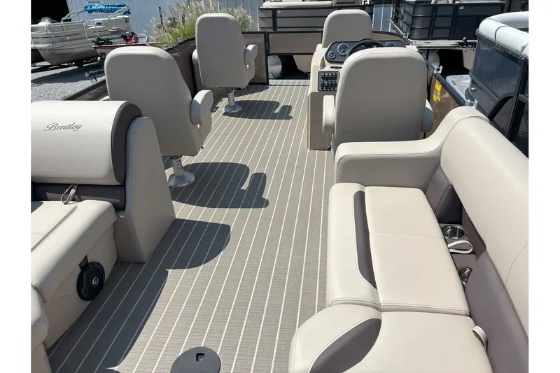 Slide: The Image of Interior of a Bentley Pontoons FISH 200 CW with beige seating and a modern helm. - 3