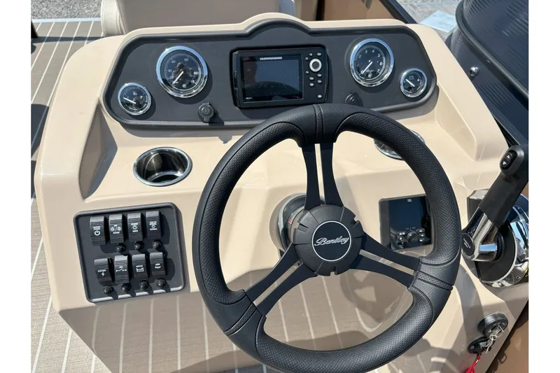 Slide: The Image of The image shows the helm of a Bentley Pontoons FISH 200 CW with steering wheel and instruments. - 6