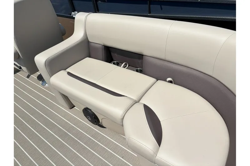 Slide: The Image of The image shows a beige bench seat on a boat with cup holders and a speaker. - 21