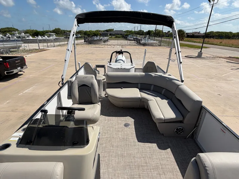 Slide: The Image of The image shows a 2022 SilverWave 2410 RLP SW3 pontoon boat with gray seating and a Bimini top. - 36