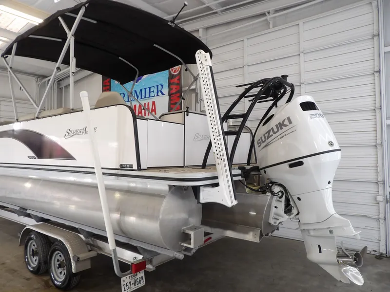 Slide: The Image of A 2022 SilverWave 2410 RLP SW3 pontoon boat with a Suzuki outboard motor on a trailer. - 17