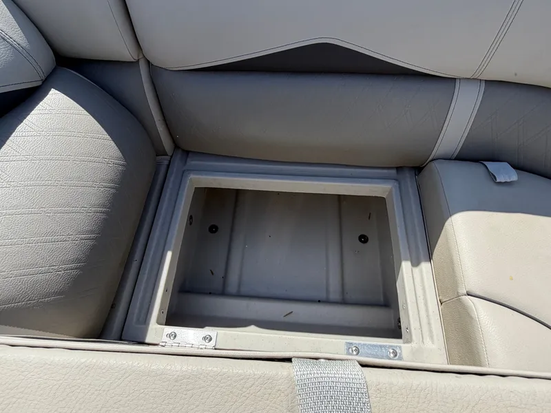 Slide: The Image of An open storage compartment in a gray boat seat with cushioned upholstery. - 34