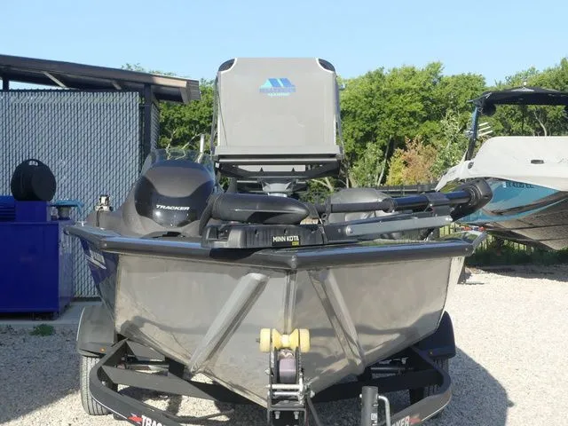Slide: The Image of A 2022 Tracker Pro Team 175 TF boat on a trailer in a gravel lot. - 3