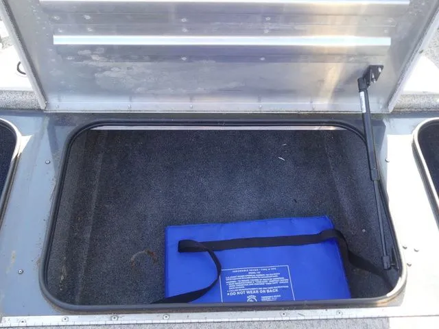 Slide: The Image of Open storage compartment with a blue bag inside. - 29