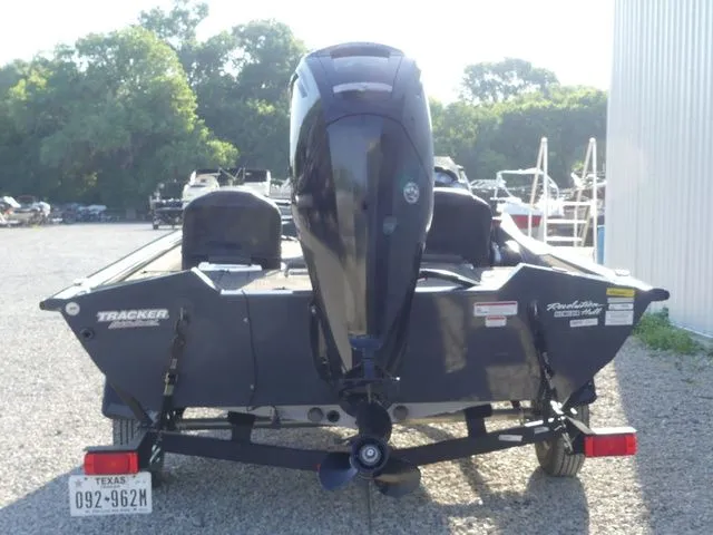Slide: The Image of Rear view of a Tracker Pro Team 175 TF boat on a trailer, featuring an outboard motor. - 6
