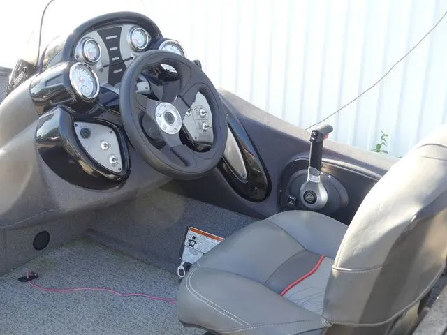 Slide: The Image of The image shows the cockpit of a 2022 Tracker Pro Team 175 TF boat with a gray seat. - 33
