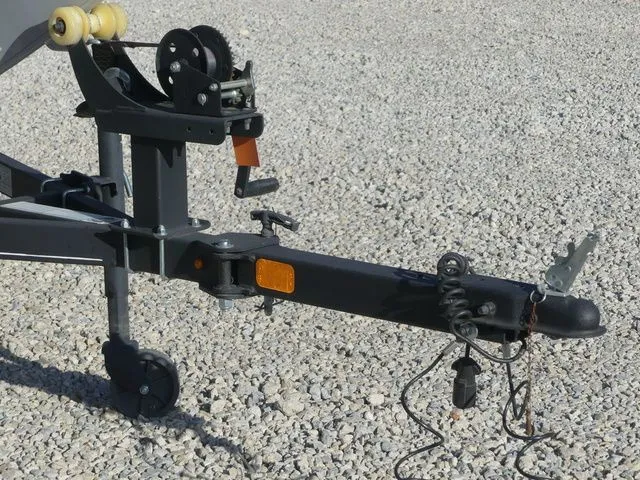 Slide: The Image of Close-up of a boat trailer on gravel, featuring a winch and hitch. - 20
