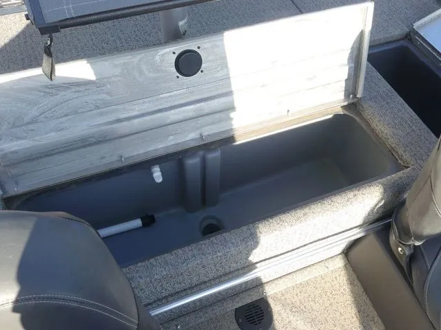 Slide: The Image of An open storage compartment on a boat with a gray interior. - 31