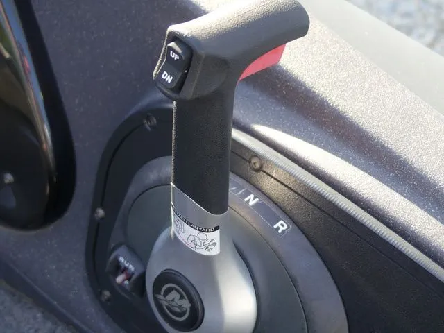 Slide: The Image of Close-up of a boat throttle lever with up and down buttons. - 38