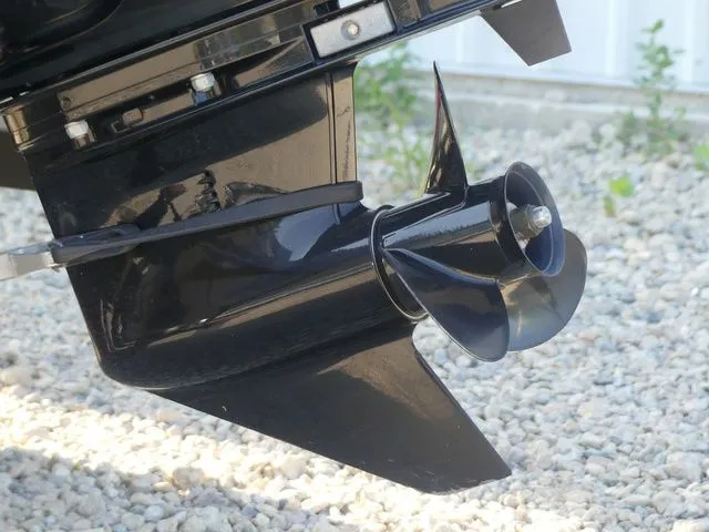 Slide: The Image of Close-up of a black boat propeller on a gravel surface. - 15