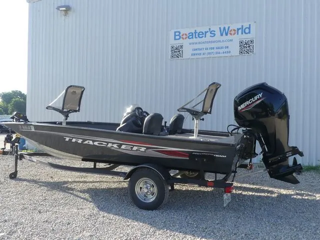 Slide: The Image of A 2022 Tracker Pro Team 175 TF boat on a trailer, parked in front of a building. - 5