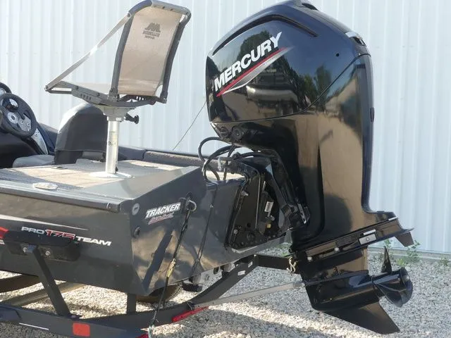 Slide: The Image of A 2022 Tracker Pro Team 175 TF boat with a Mercury outboard motor, parked on a trailer. - 12