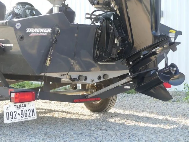 Slide: The Image of Rear view of a Tracker Pro Team 175 TF boat with outboard motor and trailer. - 16