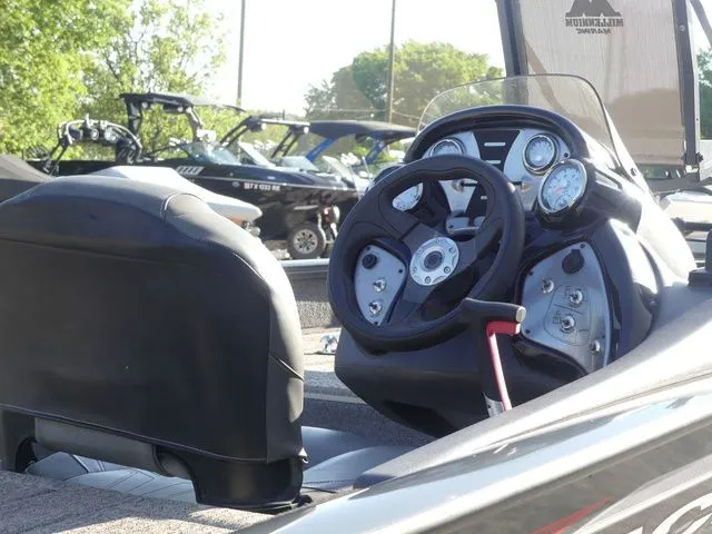 Slide: The Image of The image shows the cockpit of a 2022 Tracker Pro Team 175 TF boat with steering and instruments. - 25