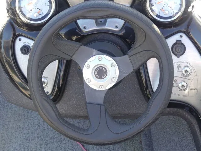 Slide: The Image of Steering wheel of a Tracker Pro Team 175 TF boat, surrounded by gauges and controls. - 35