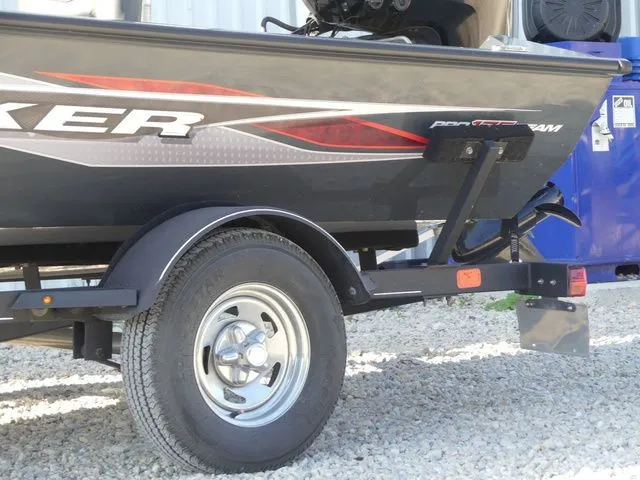Slide: The Image of A Tracker Pro Team 175 TF boat on a trailer, parked on gravel. - 18