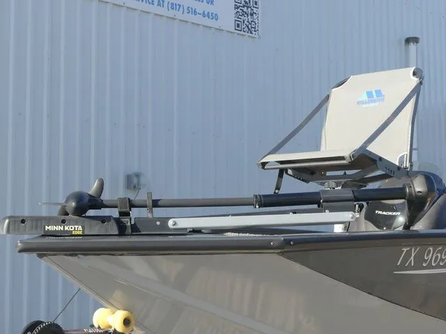 Slide: The Image of A 2022 Tracker Pro Team 175 TF with Minn Kota motor, docked by a building. - 9