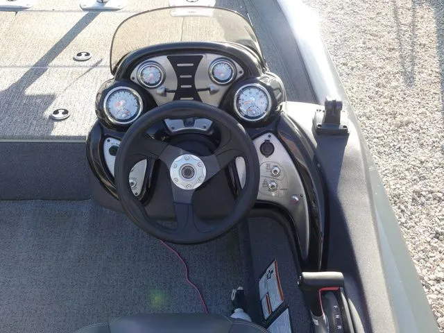 Slide: The Image of The image shows the helm of a 2022 Tracker Pro Team 175 TF boat. - 34