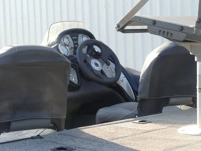 Slide: The Image of The image shows the cockpit of a 2022 Tracker Pro Team 175 TF boat with steering and instruments. - 26