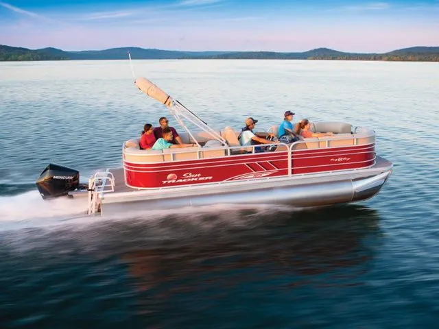 The Image of 2022 Sun Tracker Party Barge 22 XP3 on a calm lake with several people on board. - 1