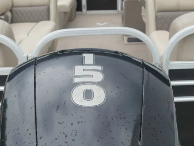 Slide: The Image of Close-up of an outboard motor labeled "150." Boat seats are visible in the background. - 26