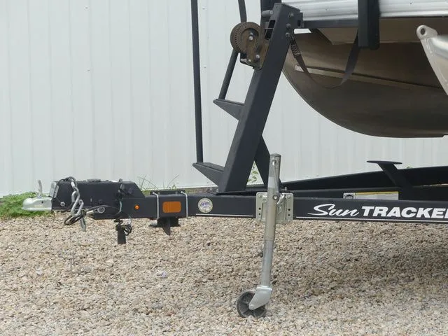 Slide: The Image of A 2020 Sun Tracker Party Barge 22 DLX on a trailer, parked on gravel. - 10