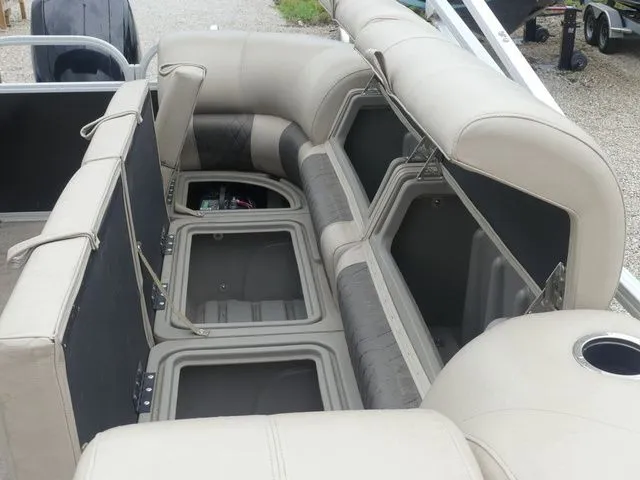 Slide: The Image of Interior view of a Sun Tracker Party Barge 22 DLX with open storage compartments. - 37