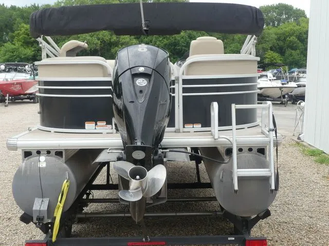 Slide: The Image of Rear view of a Sun Tracker Party Barge 22 DLX pontoon boat with an outboard motor. - 5