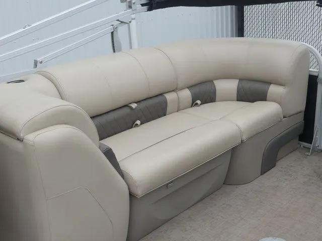 Slide: The Image of Beige seating on a boat with cushioned backrests and armrests. - 24