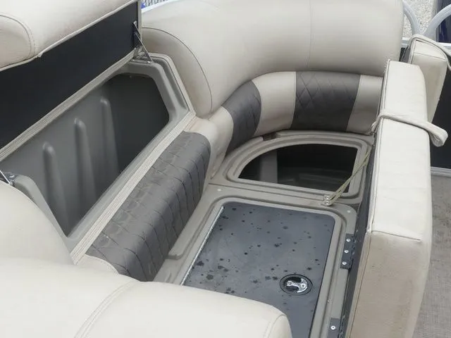 Slide: The Image of Interior of a Sun Tracker Party Barge 22 DLX with cushioned seating and storage space. - 38
