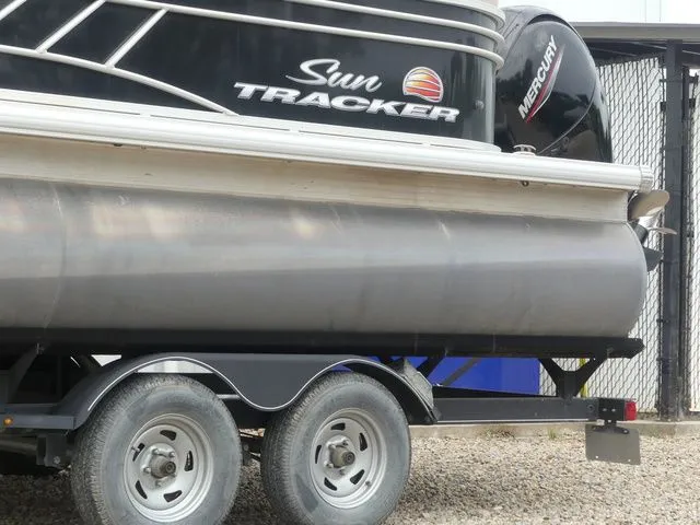 Slide: The Image of A 2020 Sun Tracker Party Barge 22 DLX on a trailer. - 9