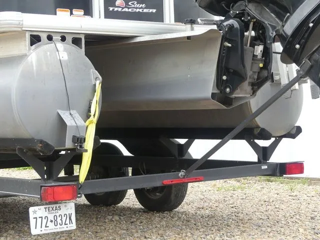 Slide: The Image of Rear view of a Sun Tracker Party Barge 22 DLX pontoon boat on a trailer. - 7