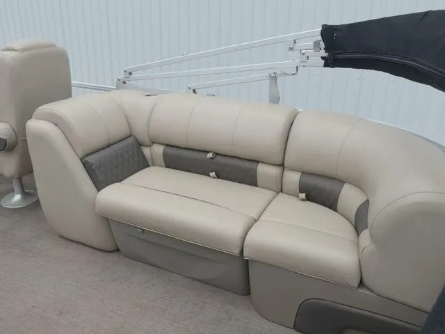 Slide: The Image of Beige seating on a boat with gray accents and a sunshade. - 28