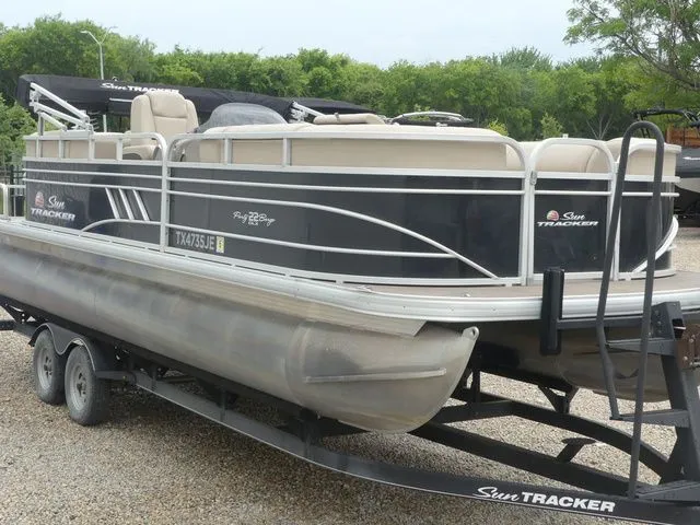Slide: The Image of A 2020 Sun Tracker Party Barge 22 DLX on a trailer, ready for adventure. - 4