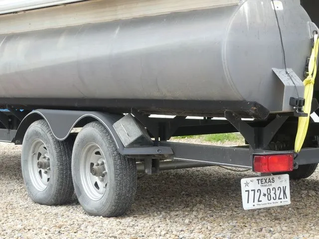 Slide: The Image of Close-up of a trailer with a Sun Tracker Party Barge 22 DLX pontoon boat. - 8