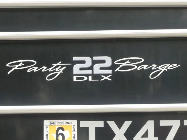 Slide: The Image of "Party Barge 22 DLX" lettering on a boat. - 14