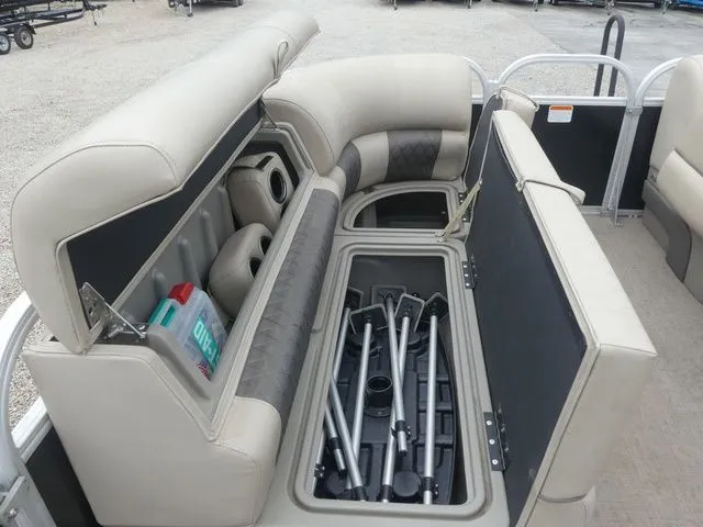 Slide: The Image of The image shows the storage area of a Sun Tracker Party Barge 22 DLX pontoon boat. - 34