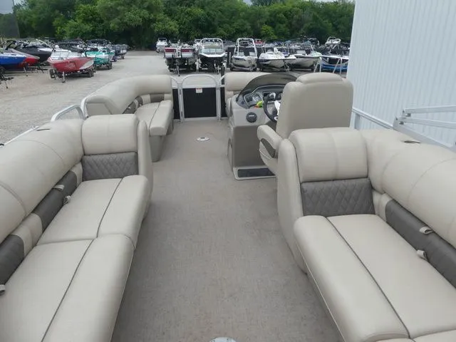 Slide: The Image of The image shows the interior of a 2020 Sun Tracker Party Barge 22 DLX with beige seating. - 27