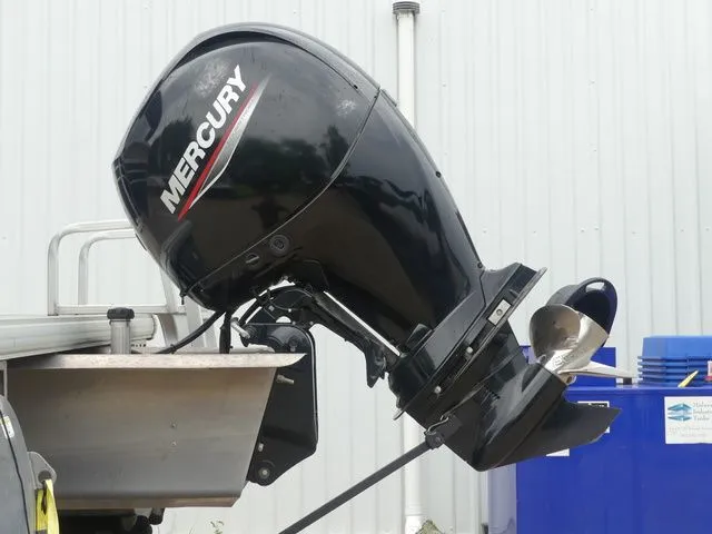 Slide: The Image of A Mercury outboard motor is mounted on a boat in a storage area. - 15