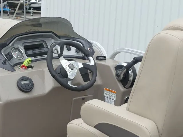 Slide: The Image of The image shows the helm of a 2020 Sun Tracker Party Barge 22 DLX. - 30