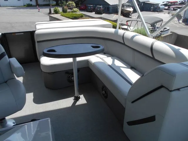 Slide: The Image of The image shows the interior of a 2024 Crest Classic LX 200 L boat with gray seating and a table. - 15