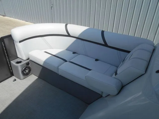 Slide: The Image of Interior view of a boat with gray upholstered seating and a speaker. - 7