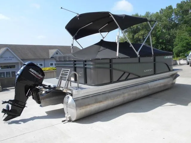 Slide: The Image of A 2024 Crest Classic LX 200 L pontoon boat with a black canopy and Mercury outboard motor. - 4